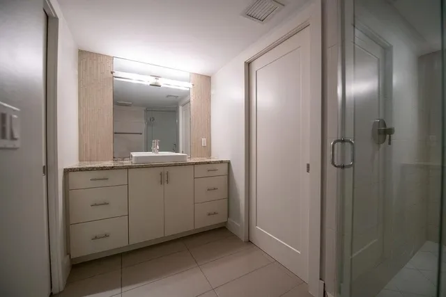 a spacious bathroom with a mirror and a double vanity sink