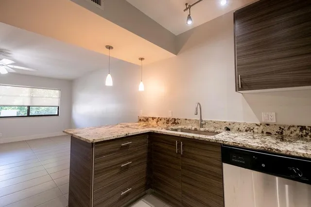 a kitchen with a sink and a wooden cabinets