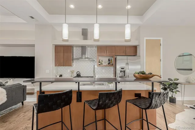 a kitchen with stainless steel appliances kitchen island granite countertop a sink and cabinets