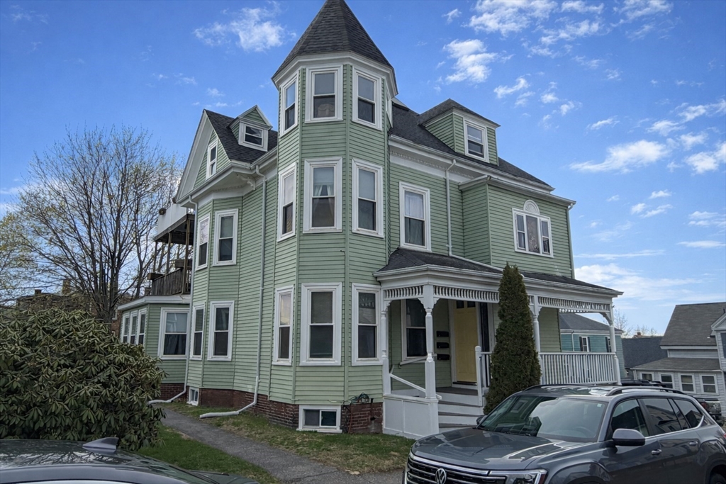 7 Judson Street, Unit 1 Beverly, MA 01915 - Photo 1 of 11 a front view of a house with a yard