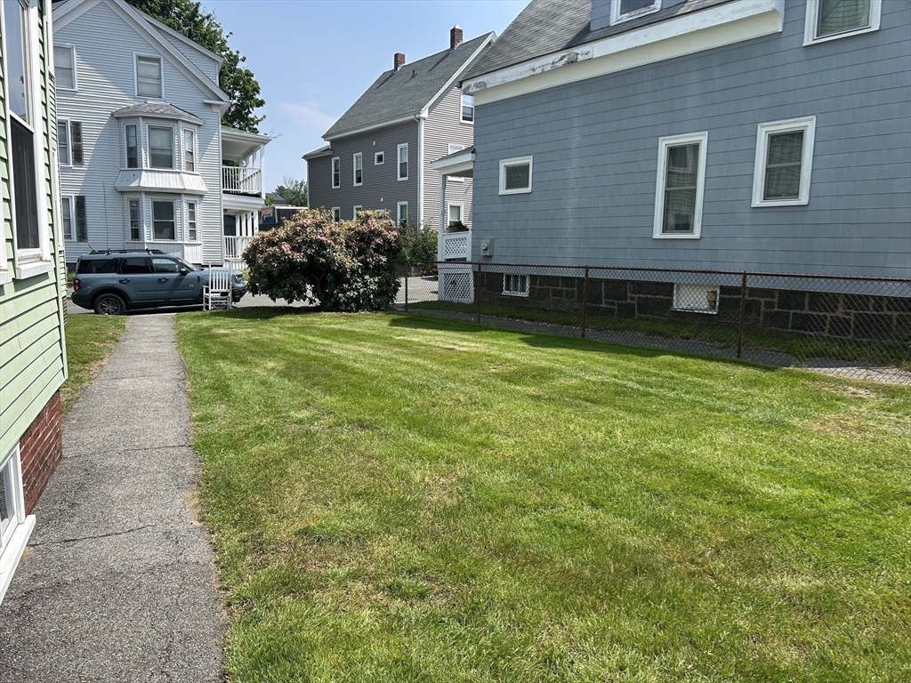 7 Judson Street, Unit 1 Beverly, MA 01915 - Photo 11 of 11 a front view of a house with a yard table and chairs