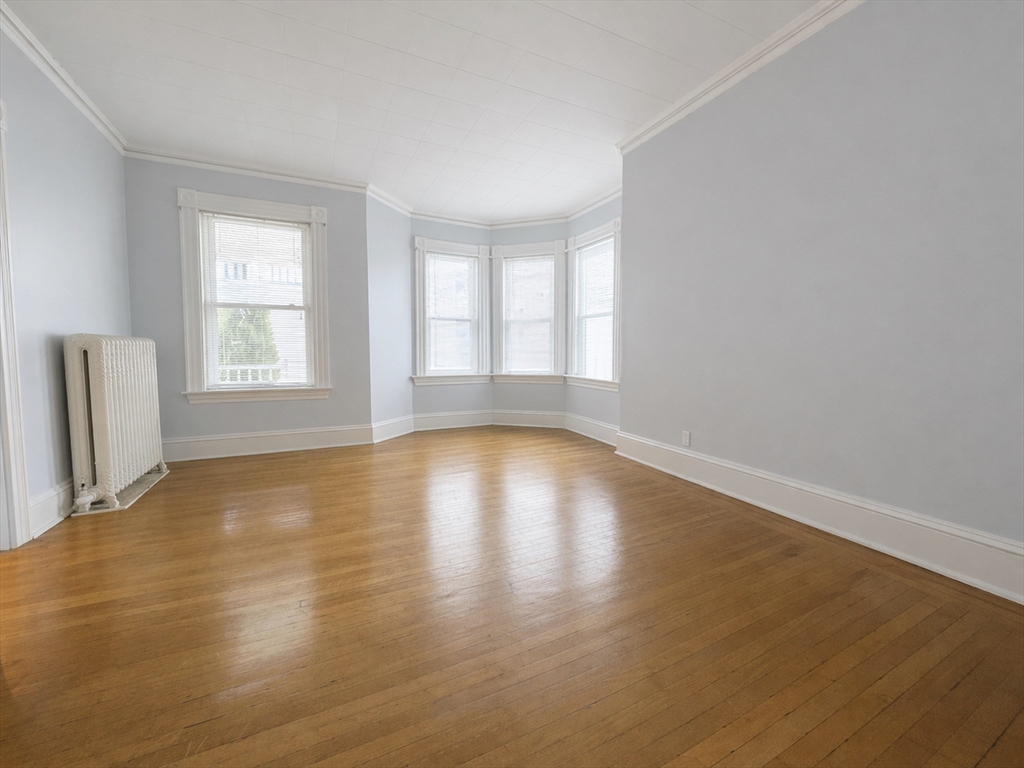 7 Judson Street, Unit 1 Beverly, MA 01915 - Photo 2 of 11 a view of empty room with wooden floor and fan