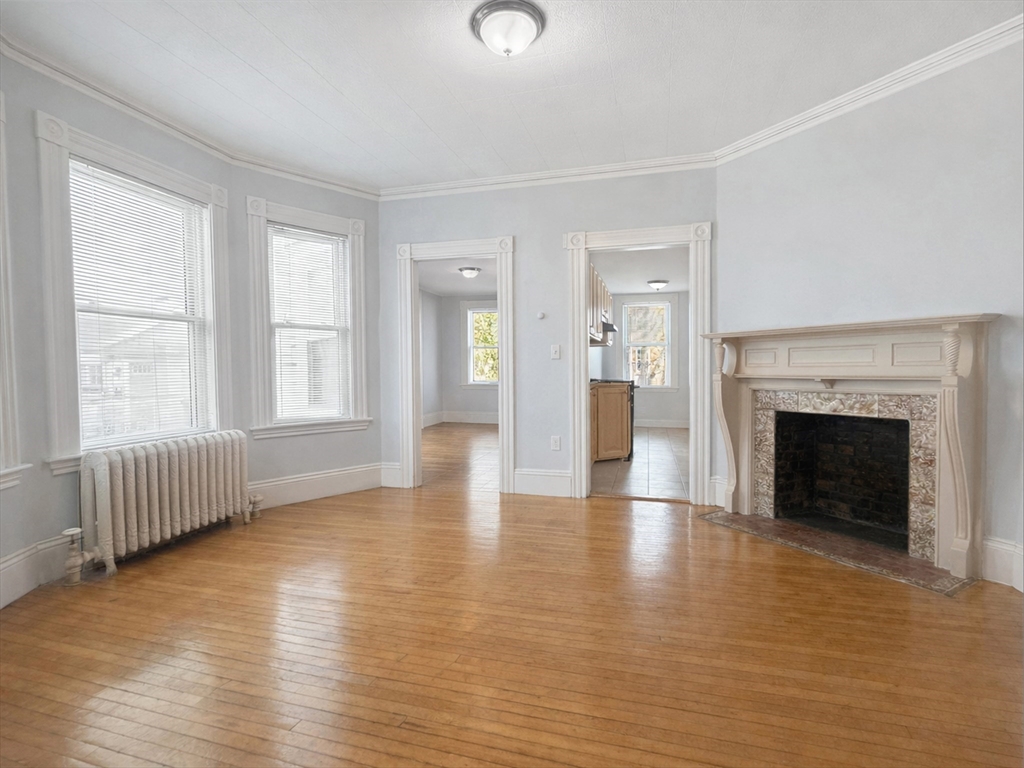 7 Judson Street, Unit 1 Beverly, MA 01915 - Photo 3 of 11 a view of an empty room with window and fire place