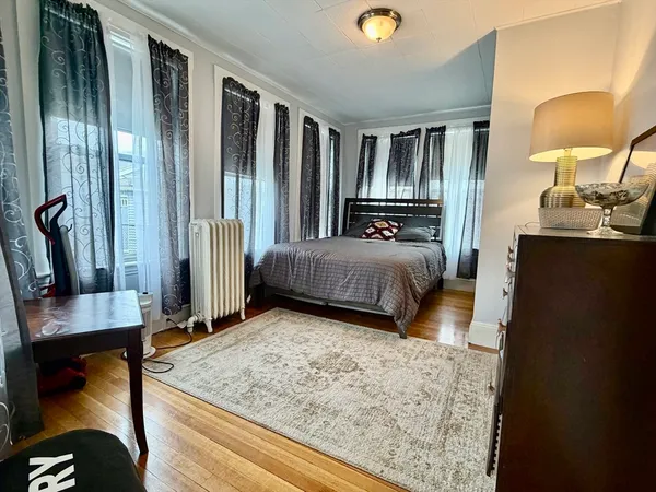 a bedroom with furniture and a flat screen tv