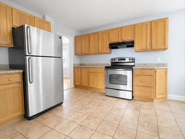 a kitchen with stainless steel appliances granite countertop a refrigerator sink and cabinets