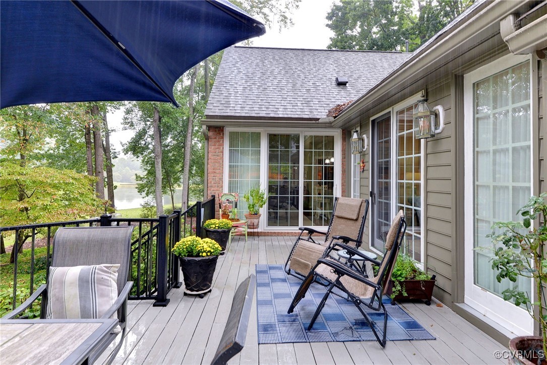 108 Harlech Williamsburg, VA 23188 - Photo 15 of 50 a view of a patio with table and chairs potted plants with wooden floor and fence