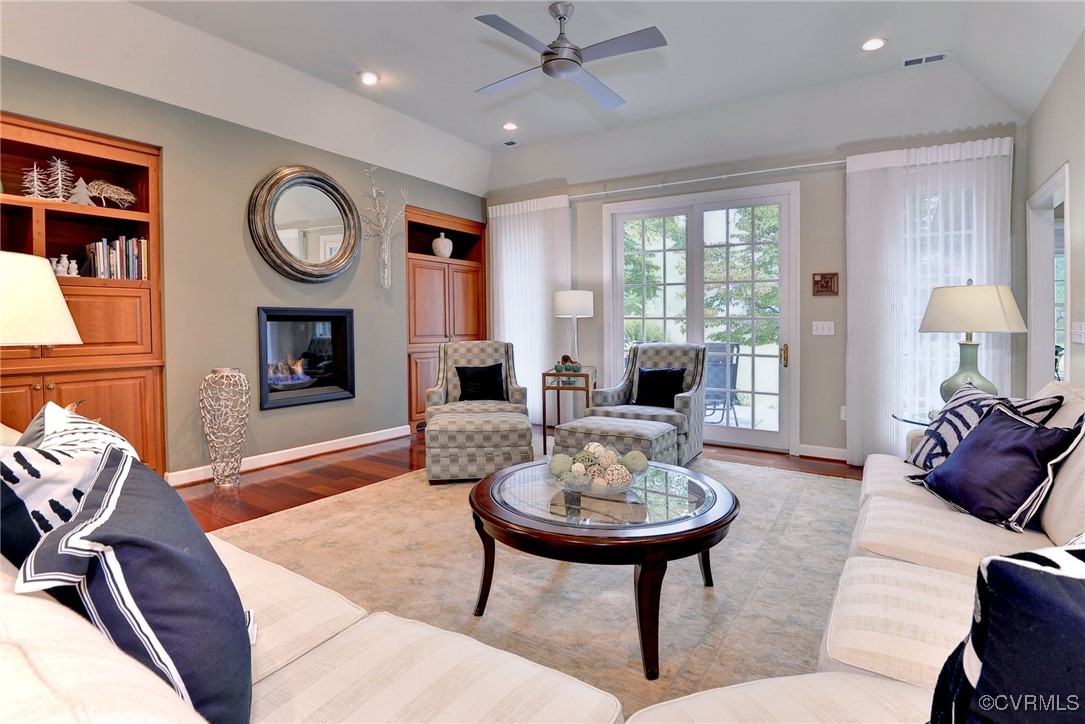 108 Harlech Williamsburg, VA 23188 - Photo 20 of 50 a living room with furniture a clock and a fireplace