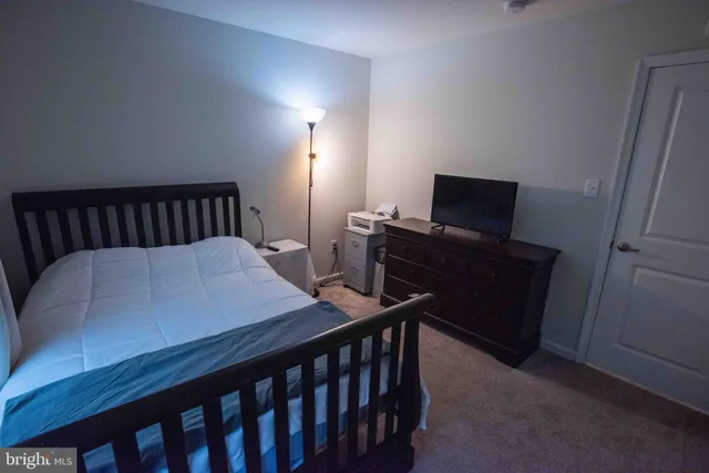 a bed sitting in a room next to a window