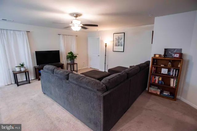 a living room with furniture a chandelier and a mirror