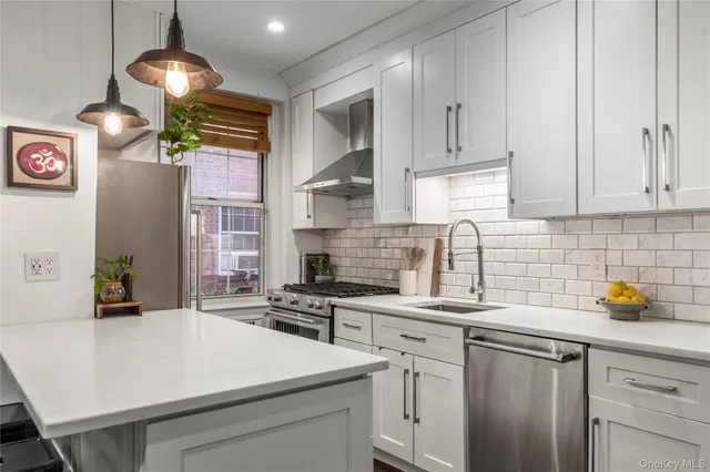 a kitchen with a sink a stove and cabinets