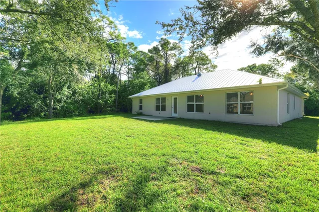 a kitchen with granite countertop a sink a stove and cabinets