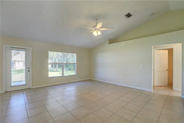 a room with a refrigerator and cabinets