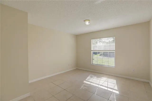 a kitchen that has a lot of white cabinets and stainless steel appliances