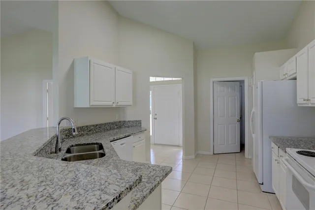 a bathroom with a granite countertop sink a mirror and a shower