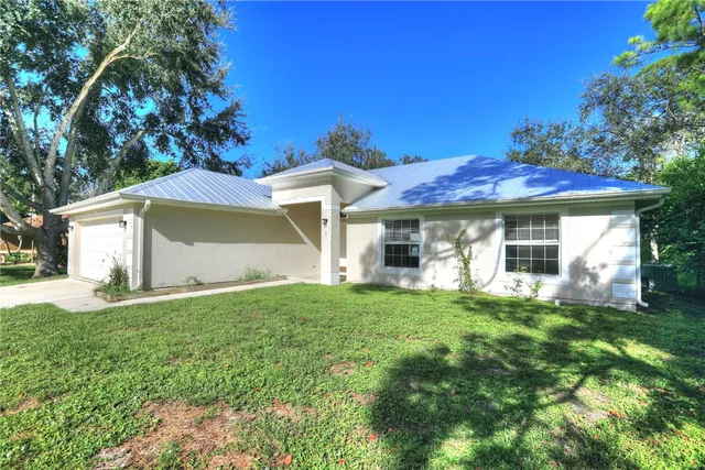 a view of a yard with a large tree