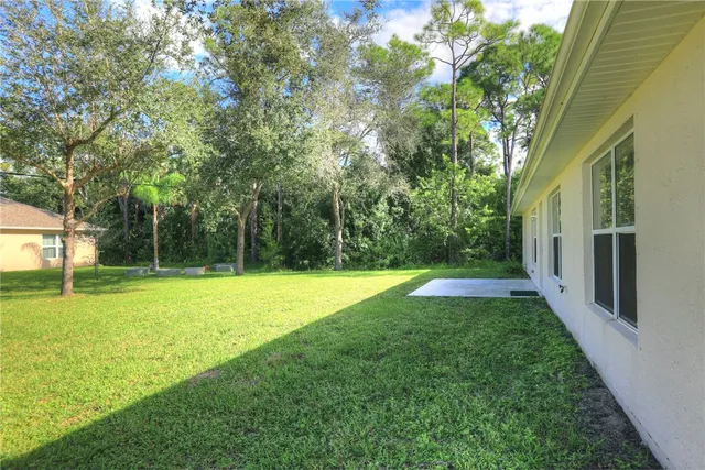 a view of a kitchen with a sink and a refrigerator