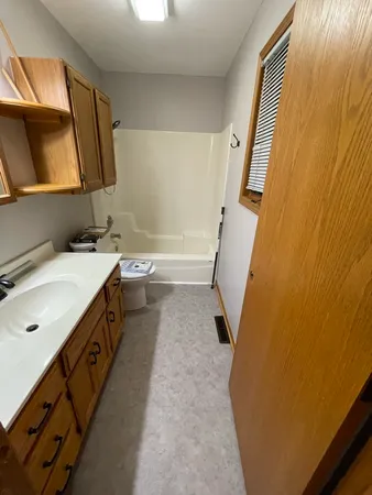 a bathroom with a sink a mirror and a bathtub