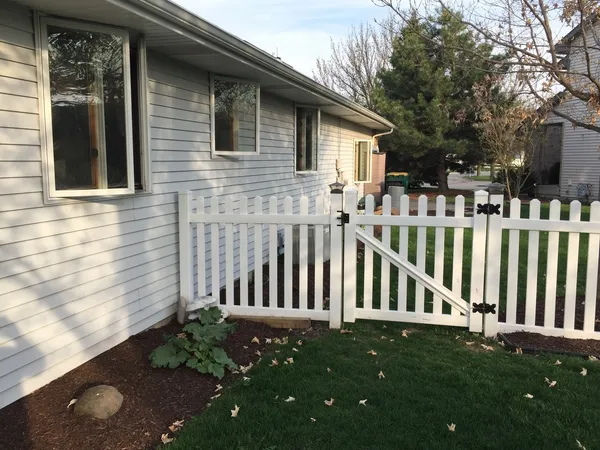 a view of a house with backyard and porch