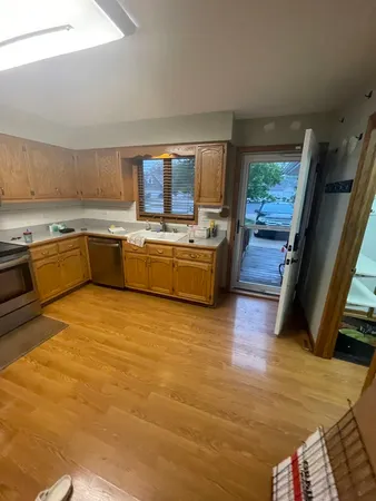 a kitchen with stainless steel appliances granite countertop a stove a sink and a refrigerator