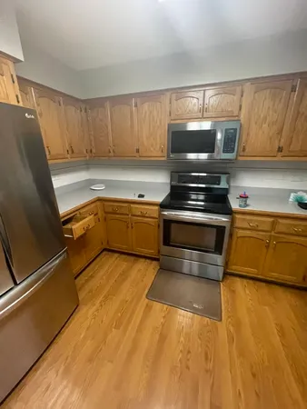 a kitchen with granite countertop a sink stainless steel appliances and cabinets