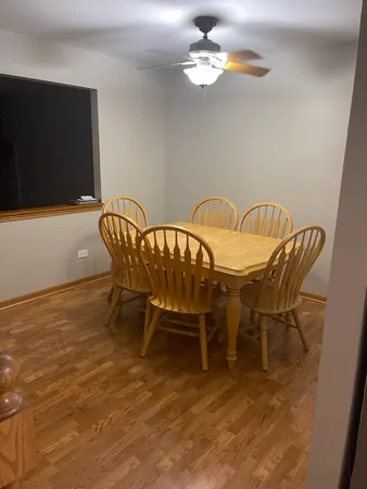 a view of a dining room with furniture wooden floor and chandelier