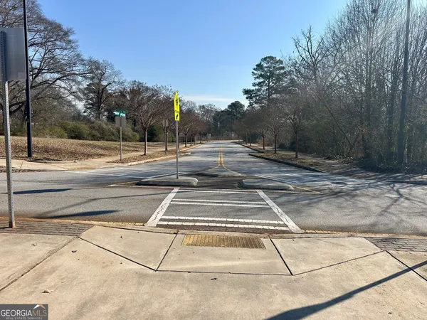 a view of a field with trees in background
