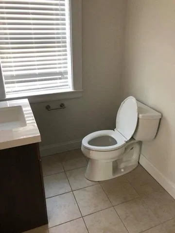 a white toilet sitting next to a sink
