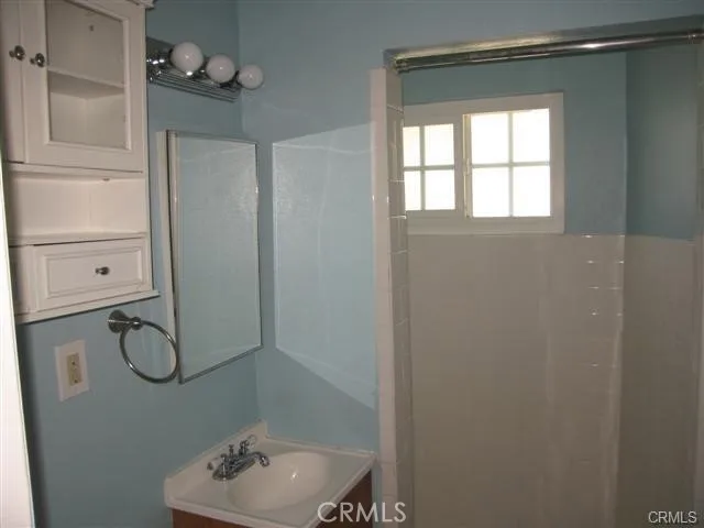 a view of a small space with wooden floor and a window