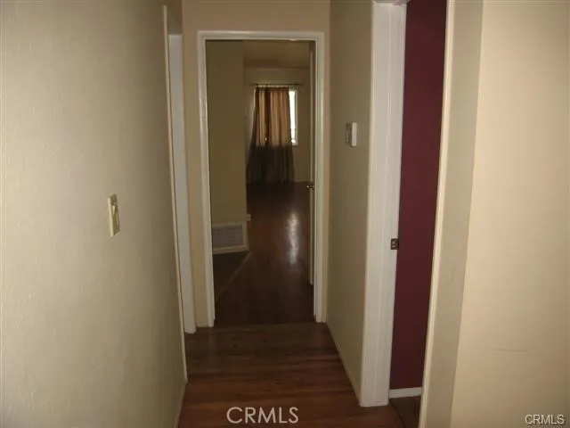 a view of wooden floor and windows in an empty room