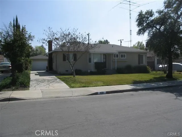 a view of a house with a garden and pathway