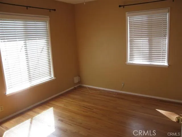 a view of an empty room and wooden floor