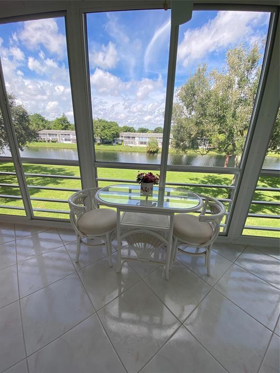 a view of a floor with a floor to ceiling window next to a yard