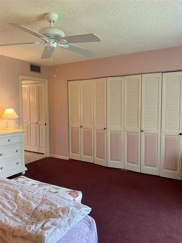 a view of a livingroom with an empty space and a ceiling fan