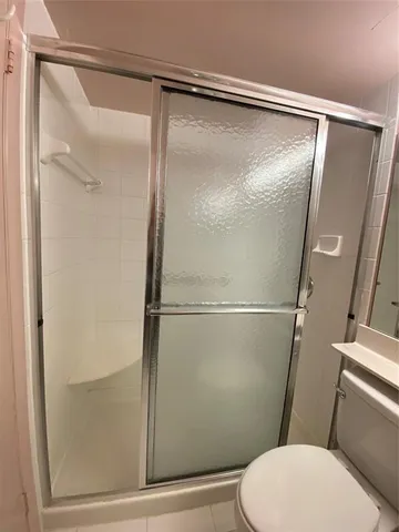 a bedroom with a bed and a night stand