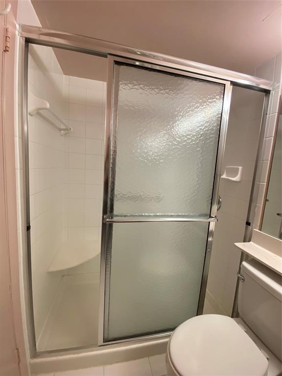3012 Westbury F, Unit 3012 Deerfield Beach, FL 33442 - Photo 16 of 54 a bathroom with a glass shower door