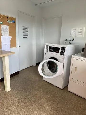 a view of a lake with couches chairs and a fire pit
