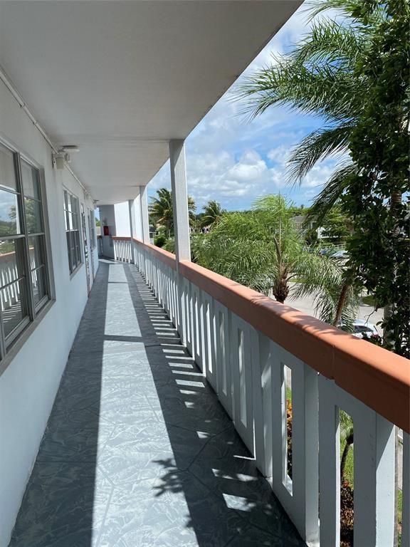 3012 Westbury F, Unit 3012 Deerfield Beach, FL 33442 - Photo 23 of 54 a view of a balcony with wooden floor