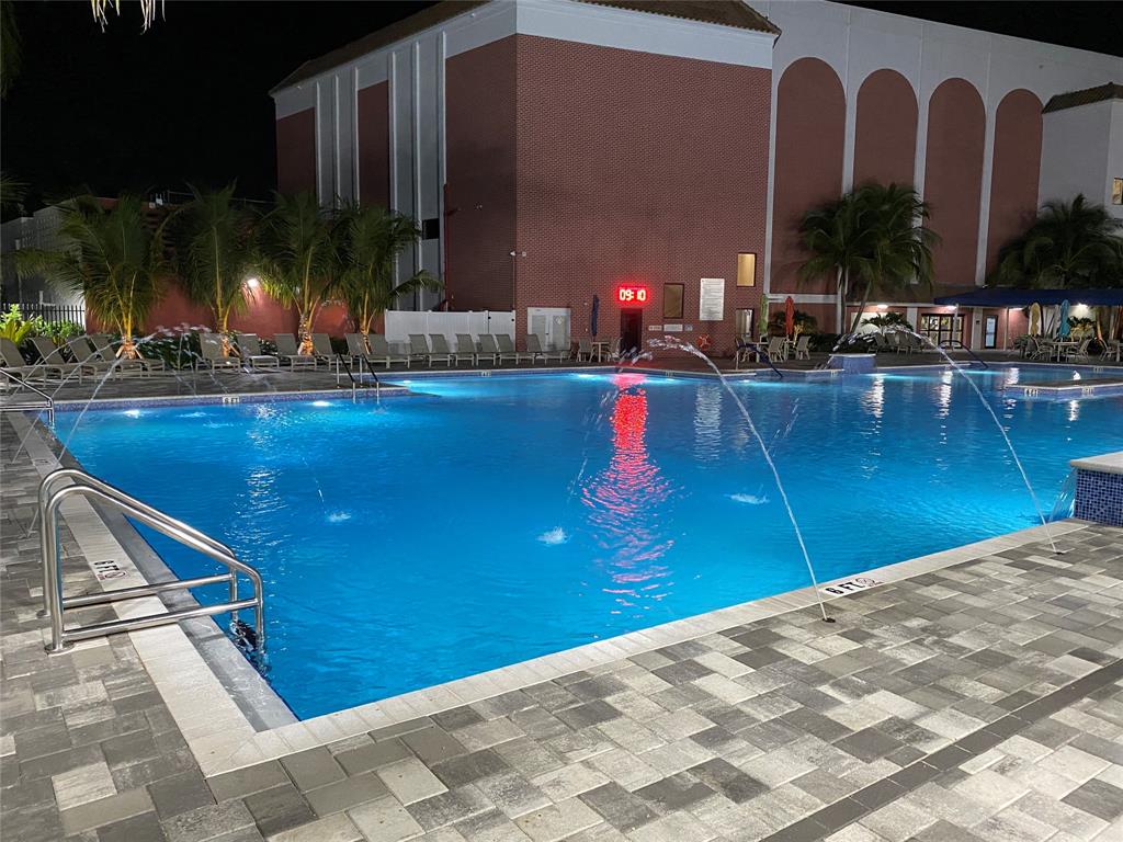 3012 Westbury F, Unit 3012 Deerfield Beach, FL 33442 - Photo 48 of 54 a view of swimming pool with outdoor seating