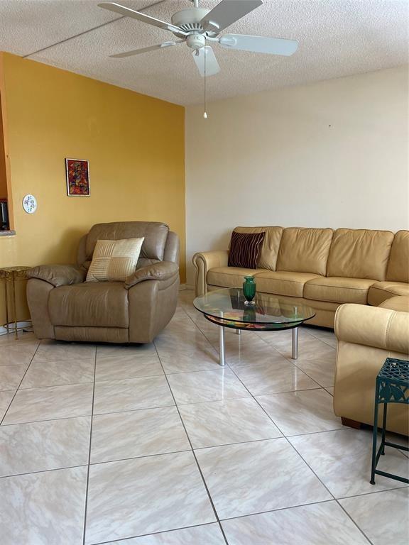 3012 Westbury F, Unit 3012 Deerfield Beach, FL 33442 - Photo 8 of 54 a living room with furniture and a rug