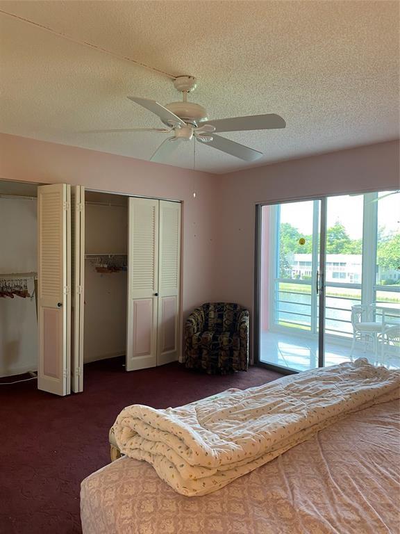 3012 Westbury F, Unit 3012 Deerfield Beach, FL 33442 - Photo 10 of 54 a bedroom with a bed and a large window
