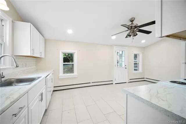 a kitchen with a sink cabinets and window
