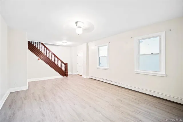 a view of an empty room with wooden floor