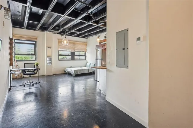 a view of a livingroom with furniture wooden floor and windows