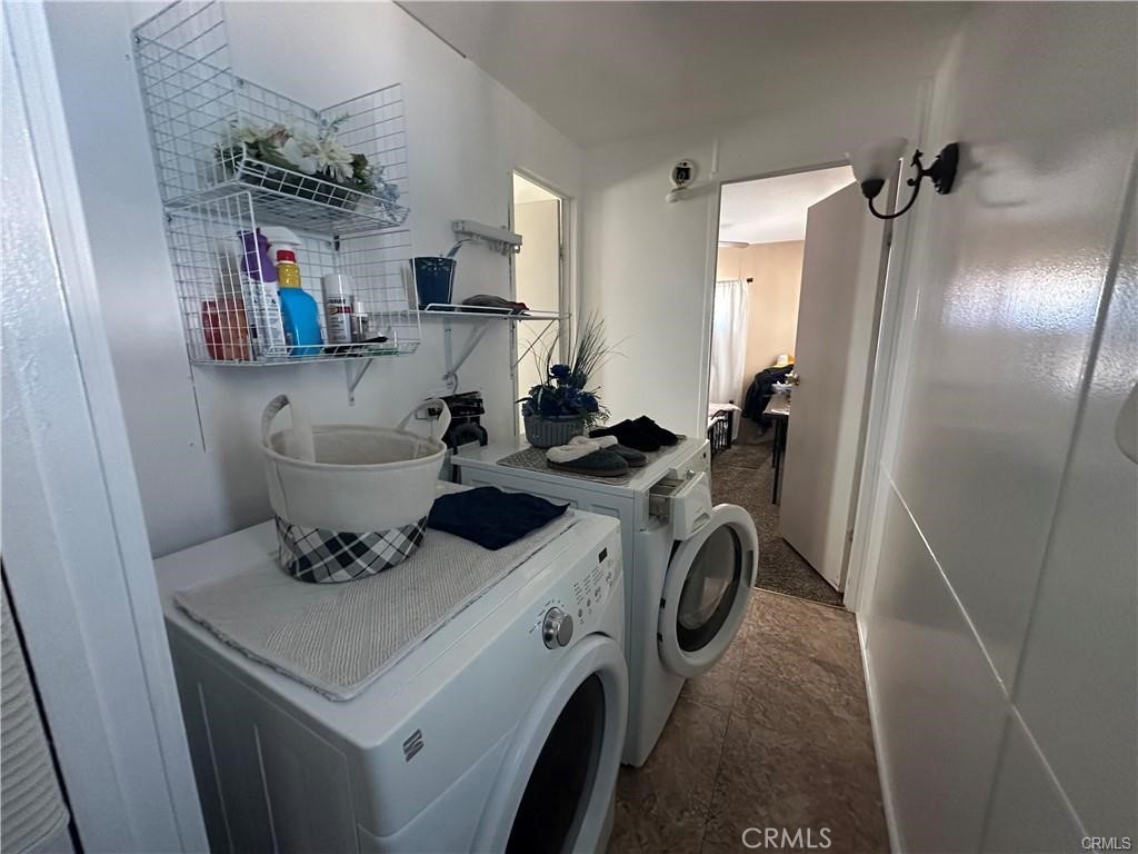 2598 Ayala Drive, Unit 34 Rialto, CA 92377 - Photo 12 of 13 a bathroom with a sink a toilet and a mirror