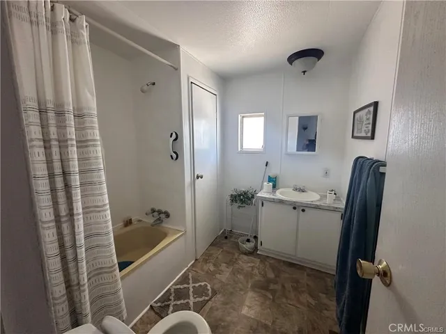 a bathroom with a tub sink and mirror