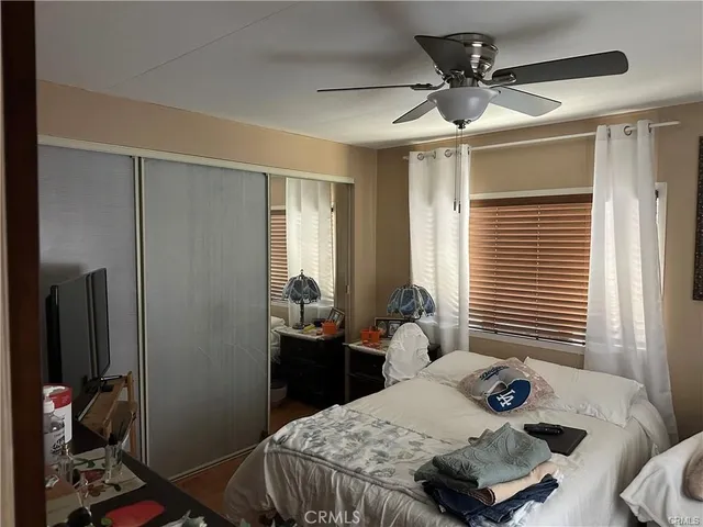 a bedroom that has a bed and a chandelier