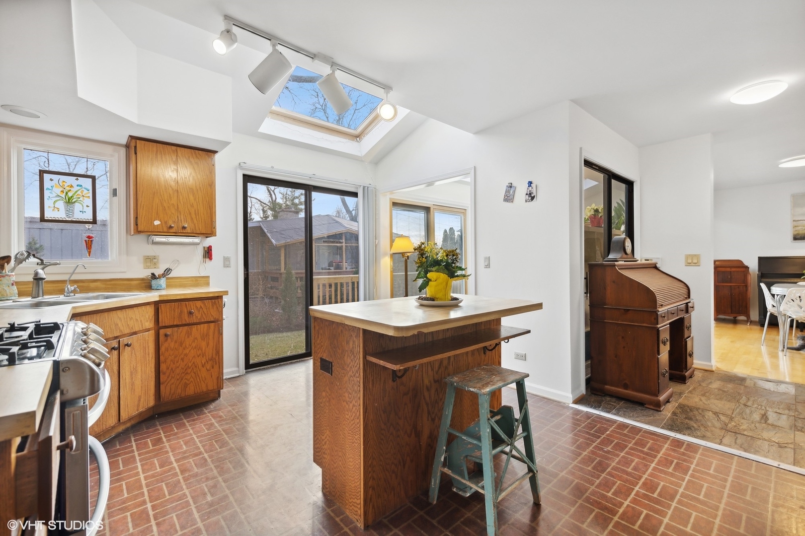 1908 Cherry Street Wheaton, IL 60187 - Photo 12 of 36 a kitchen with stainless steel appliances granite countertop a sink a stove a refrigerator a washer dryer and dining table