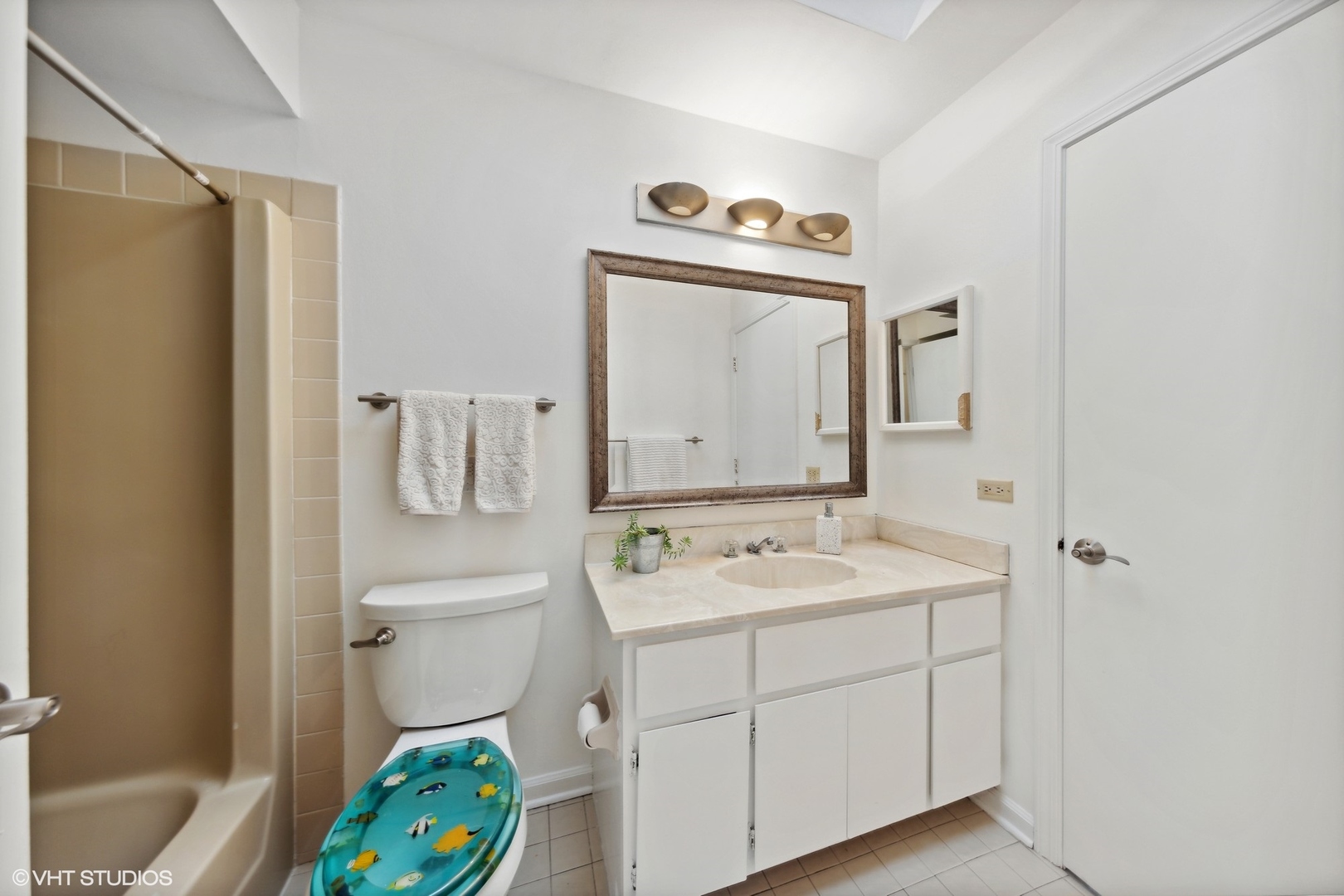 1908 Cherry Street Wheaton, IL 60187 - Photo 21 of 36 a bathroom with a sink a toilet and a mirror