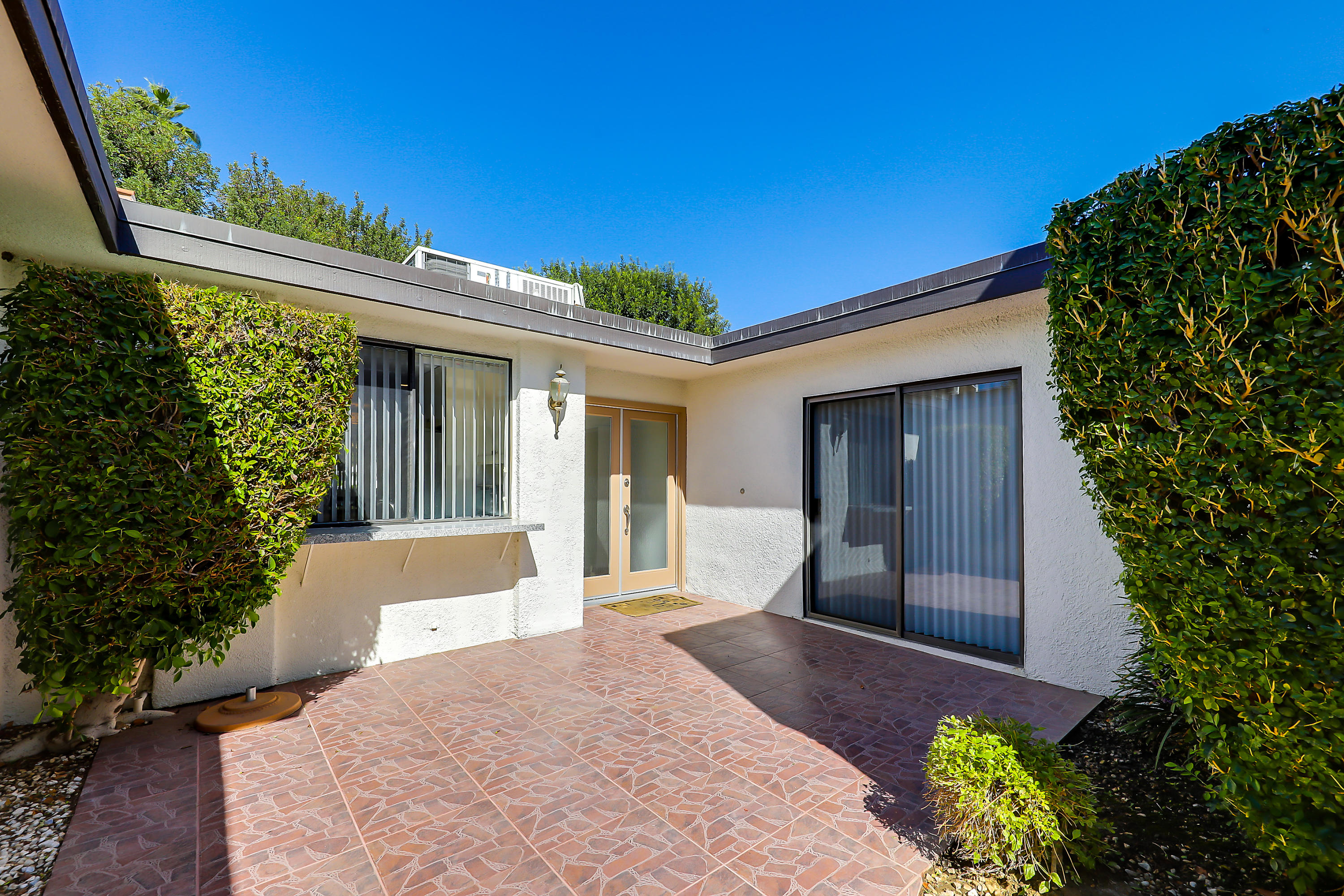 4 Leon Way Rancho Mirage, CA 92270 - Photo 16 of 20 a front view of a house with a yard