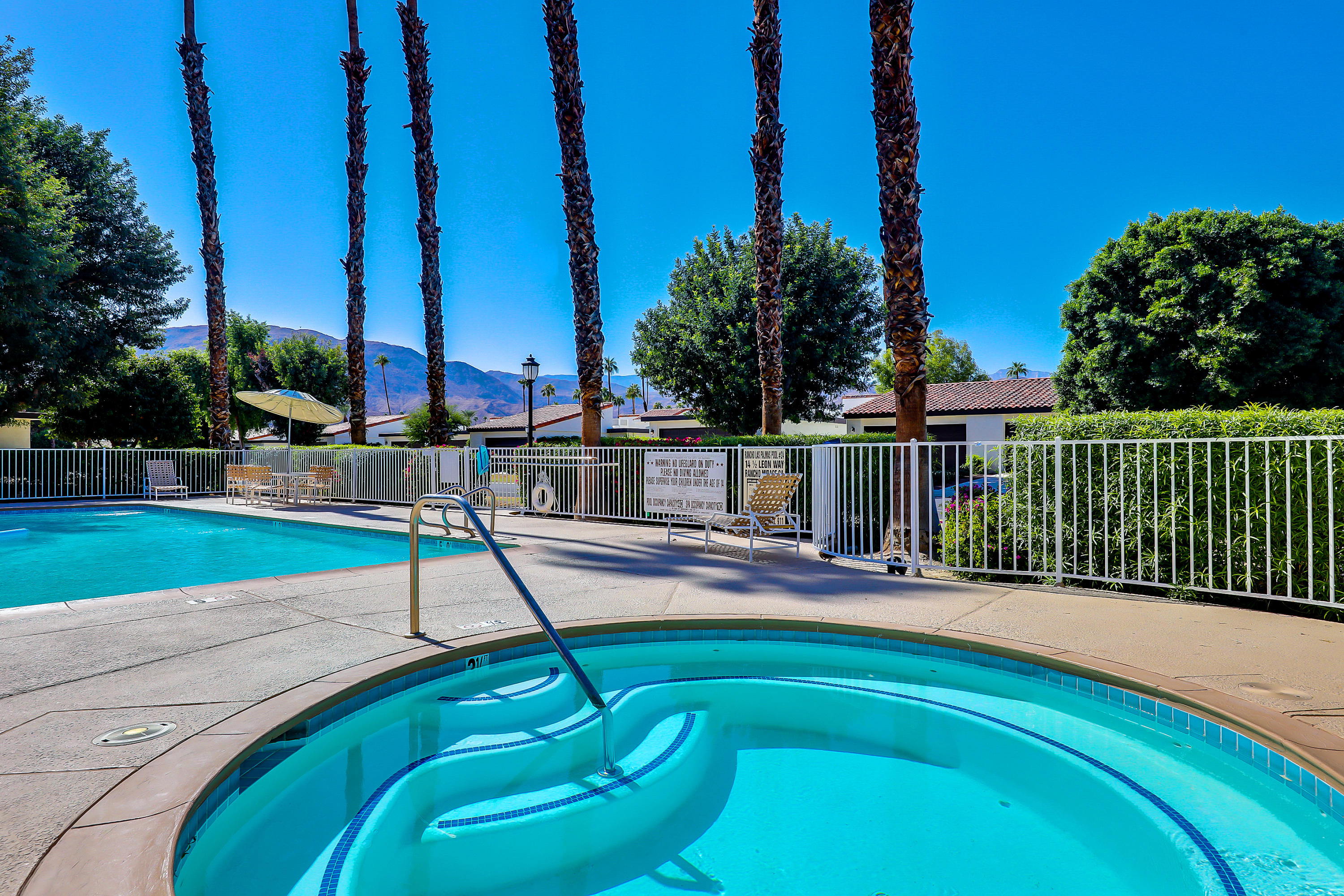 4 Leon Way Rancho Mirage, CA 92270 - Photo 19 of 20 a view of a swimming pool with a patio and a yard